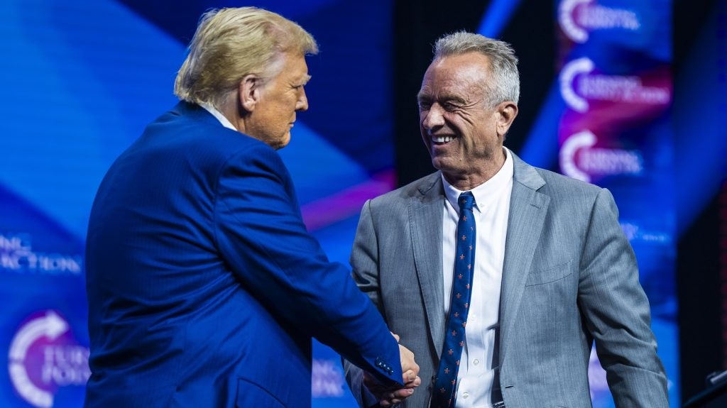 Robert F. Kennedy Jr. speaks with the now President-elect Donald Trump at a Turning Point Action Rally in Duluth, Georgia, on 23 October 2024.