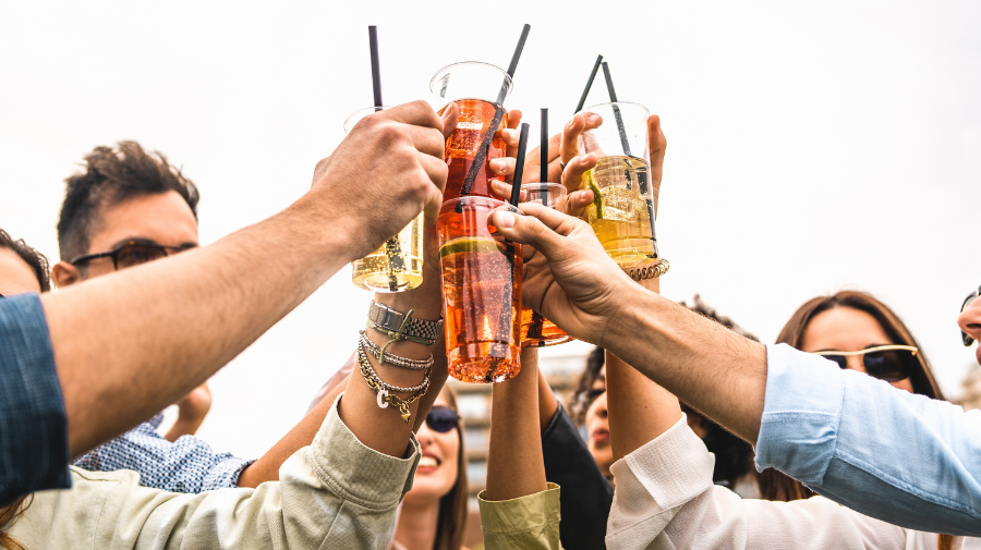 People toasting with spritz and fruit cocktails.
